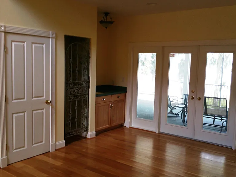 This is the wet bar and wine closet off of the foyer overlooking the main screened in porch overlooking the lake and pool deck.
