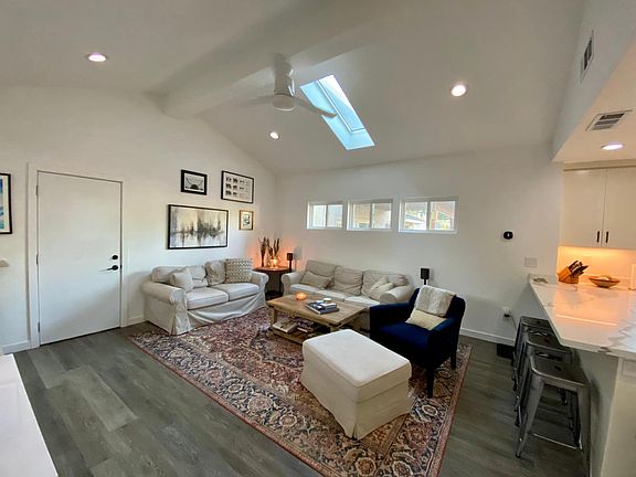 Living Room view from the front door. The door (in the picture) remains locked, with an empty room on the other side.