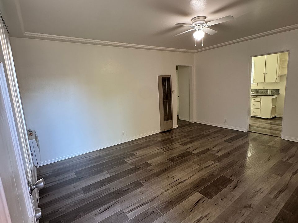 Living Room from the Main Entrance viewpoint and includes wall heater & a peak into the kitchen
