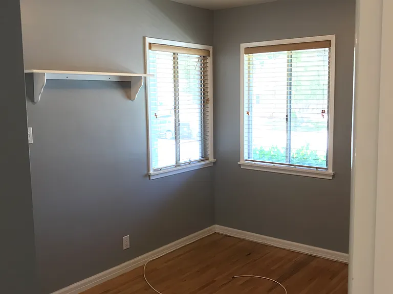 Third, small bedroom at front of house has original oak flooring and original closet.