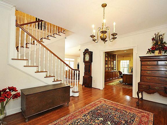 Elegant grand foyer with gleaming oak hardwood flooring