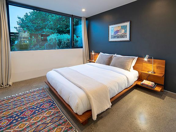 Spacious bedroom with queen bed and walk-in closet.