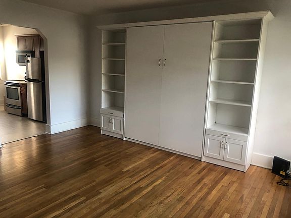 View of Murphy bed and archway to Kitchen