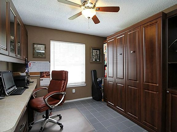 Tiled Study. Excellent for home office or student. Built in desk and cupboards. Right side of room is a full-size Murphy bed- it stays.