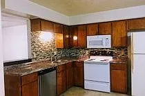 This upgraded kitchen has a tile backsplash, deep double stainless steel sinks, high fixture, lovely and inviting with a dine in kitchen. - 2410 Bosque Dr #D
