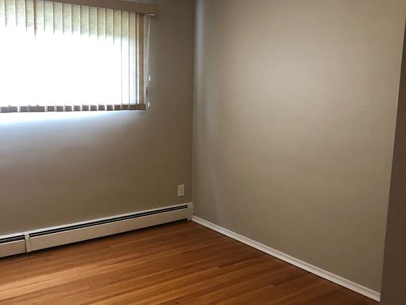Bedroom with hardwood flooring