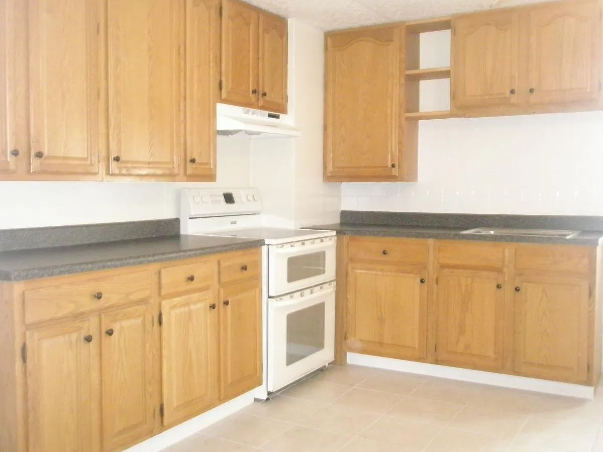 Previous kitchen...cabinets currently being professionally painted white. (They will look great) Brand new electric stainless stove and over the range microwave being added.