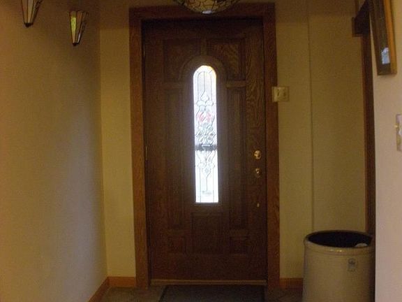 Adjust from the outdoors to the indoors in this inviting ceramic-tiled foyer.