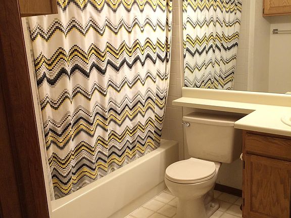 up stairs bathroom with sky lights