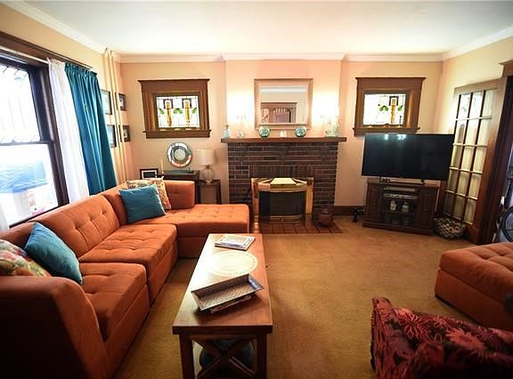 French doors lead from the living room into the formal dining room.  Stained glass windows also accent the living room.