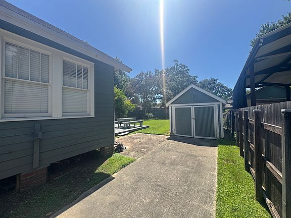 Backyard view as well as storage shed