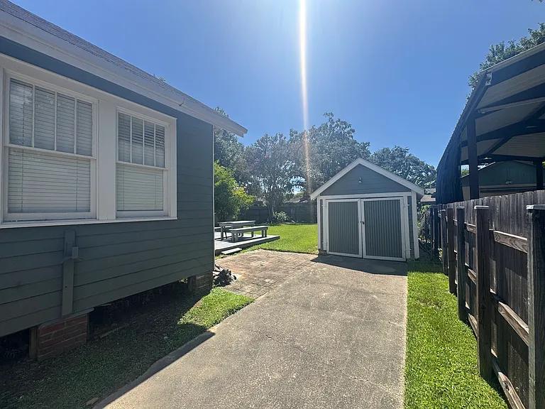 Backyard view as well as storage shed