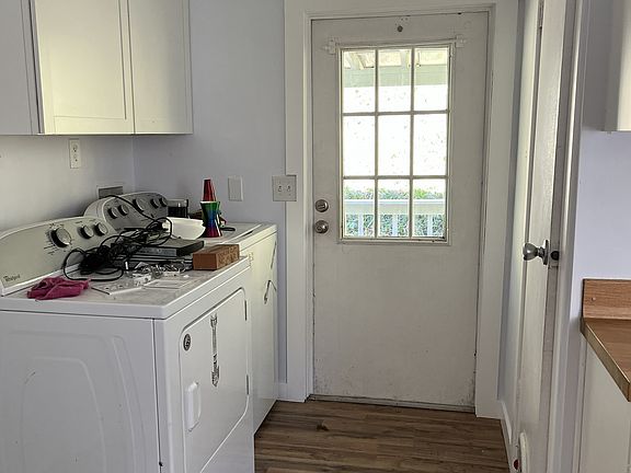 View of back door, largest bedroom to left
