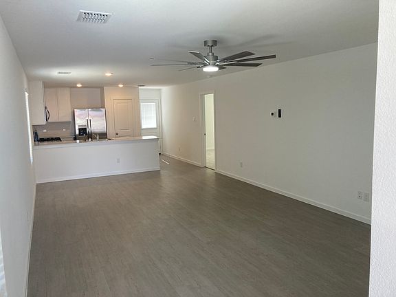 Dining Room, and Kitchen taken from Family Room. Open door in the background leads to the primary bedroom.