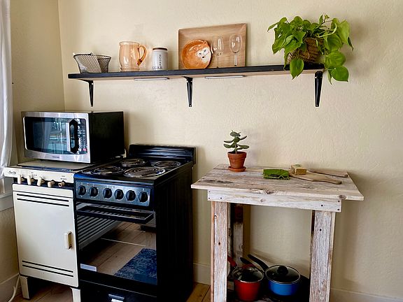 Kitchen includes Large Microwave Oven, 4 electric eyes and oven with warmer drawer, floating shelf, space for a bistro table and chairs