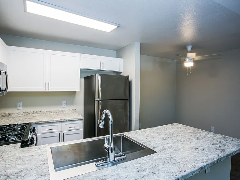 Fully equipped kitchen with stainless steel appliances, gas range, and granite counters.