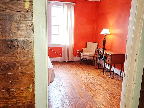 2nd Floor Orange Side yard view, 2 windows, King bed, dresser, wood floor, window AC/Heat unit, dedicated work station, NO TV