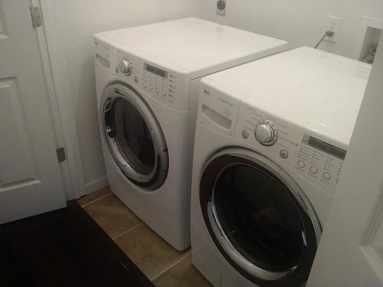 The unit includes a substantial laundry room, with washer an