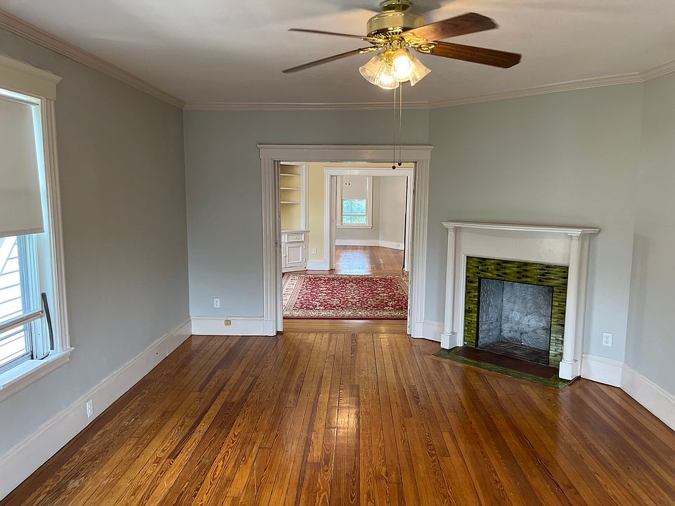 huge fireplace living room with pocket doors open to dining room and master bedroom provides incredible natural light throughout the home.
