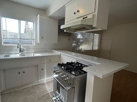 kitchen with new sink, stove, refrigerator, and countertops