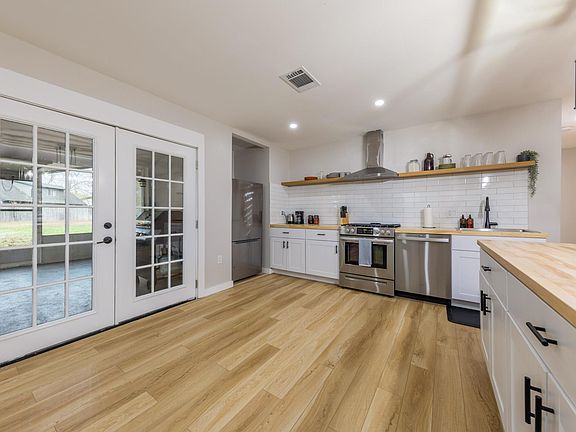 French doors open the kitchen to the screened-in porch