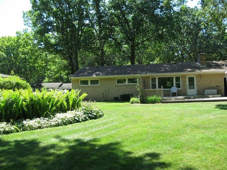 BEAUTIFUL PERENNIAL GARDENS IN THE SPACIOUS BACK YARD