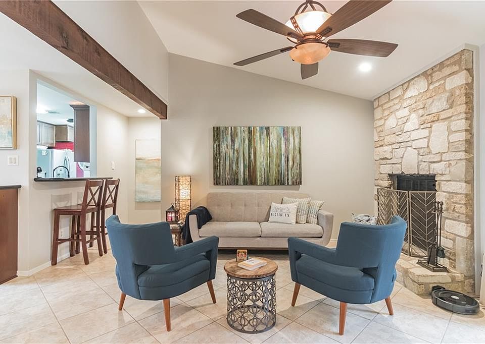 Cozy living room with nice fireplace for cold winter nights. High ceilings in the living room. Ceiling fan. Breakfast bar for two.