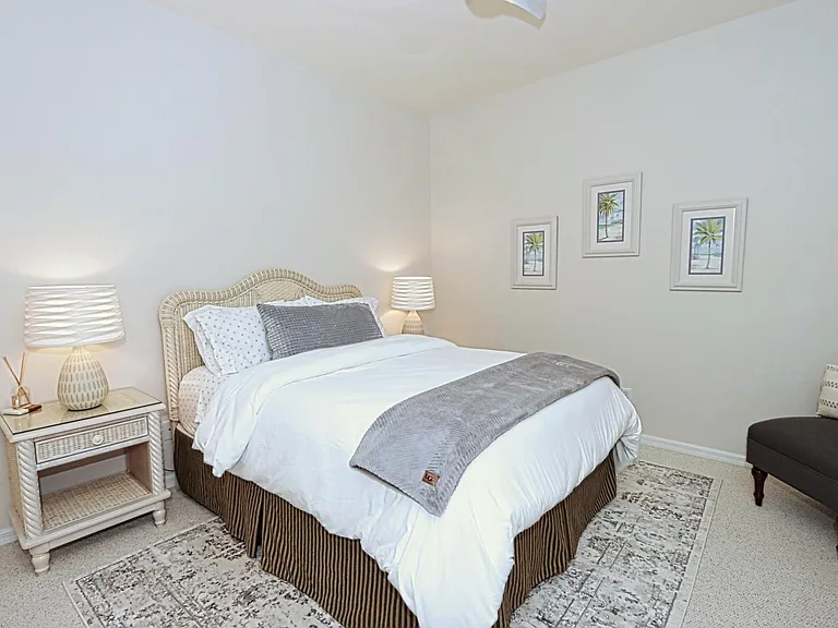 Guest Bedroom features a queen-size bed, TV, and large closet.