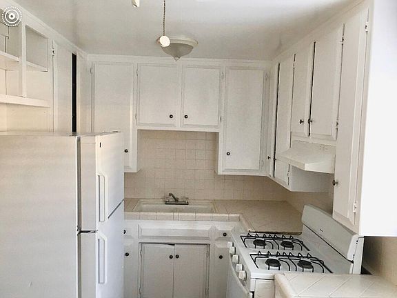 Freshly painted kitchen with refrigerator and stove/oven