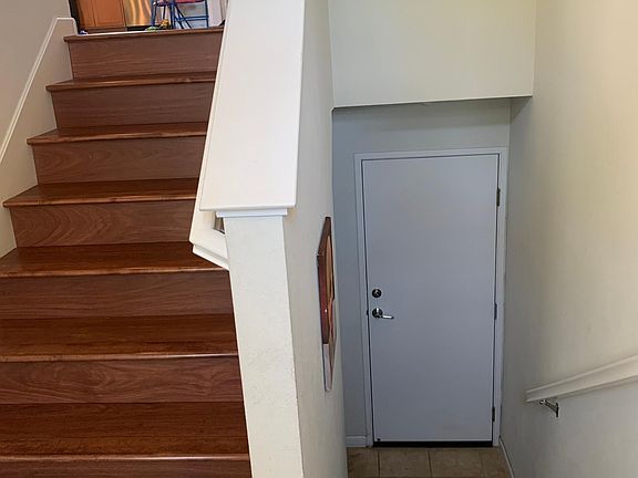 Stairs towards living room, and stairs towards garage
