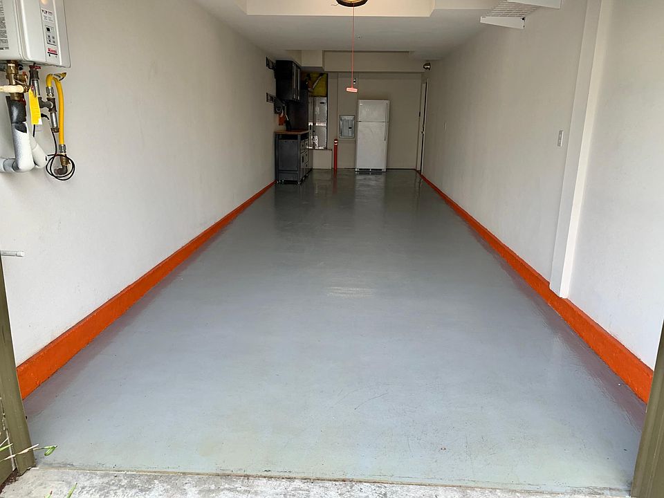 Finished Tandem Garage with Refrigerator and Storage Cabinets