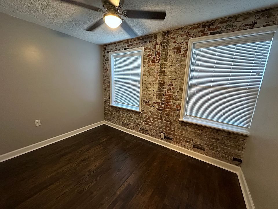 Bedroom - smaller space, but tons of character! Exposed brick and refinished original oak floors