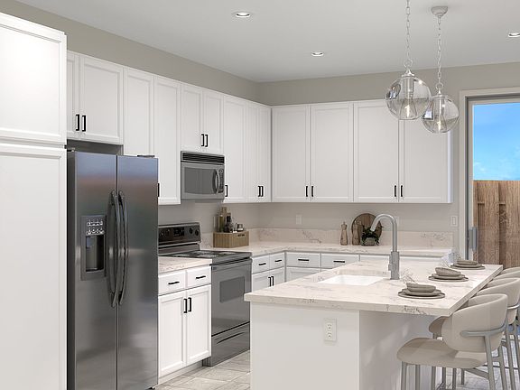 The Kitchen features stainless steel appliances and large Kitchen Island with seating for casual din