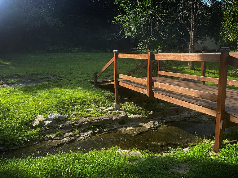 Traverse the newly completed bridge over a serene stream flowing through your wooded backyard. Hang a hammock in the shade between two tall trees, or enjoy sitting around a fire pit in the evening with friends.