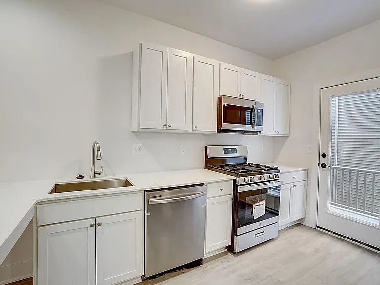 gas range, full size microwave door to deck, quiet dishwasher with top mount controls, zero radius sink, pullout faucet, offset drain so trash fits below
