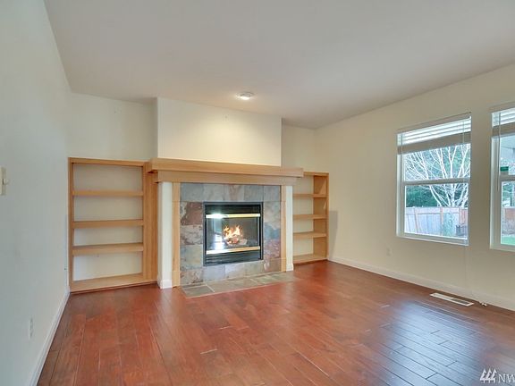 Family Room w/ built in shelving and stone fireplace.