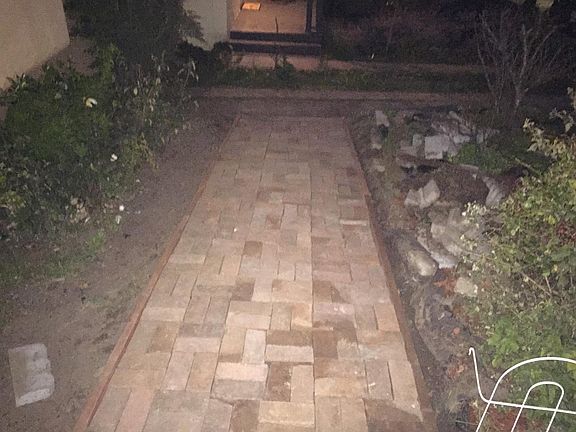 Brick Path between walkway and driveway.