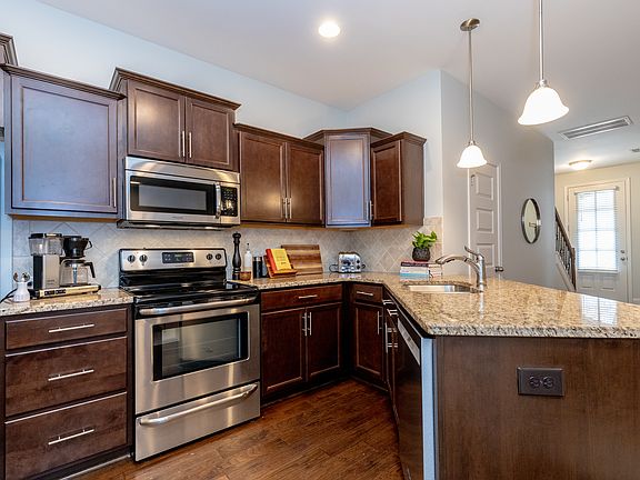 stainless steel refrigerator, dishwasher, microwave, stove and granite counter tops