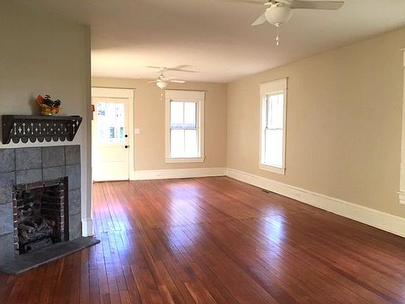 From front door, partial view , living room and dining area. Remote gas fireplace, view of back door to brick patio. LIVING & DINING ROOM HAS FOUR WINDOWS, plus all glass storm doors!