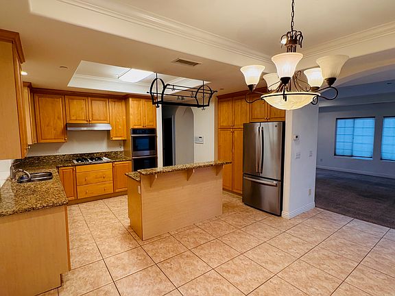 Huge dining room and large open kitchen with island and built in rack for pots and pans