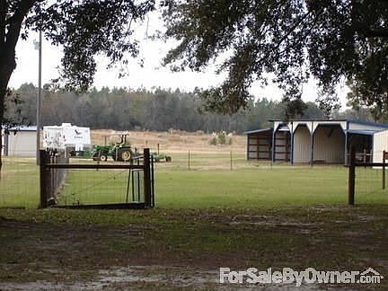 looking South from house yard
						:
						A view of the 5 stalls for equipment (tractor, mowers etc)