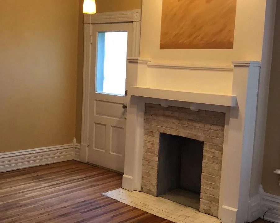 Large dining room with track lighting and mantle.