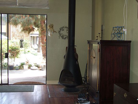 Pot Belly Wood Burning Fireplace in Living Room.