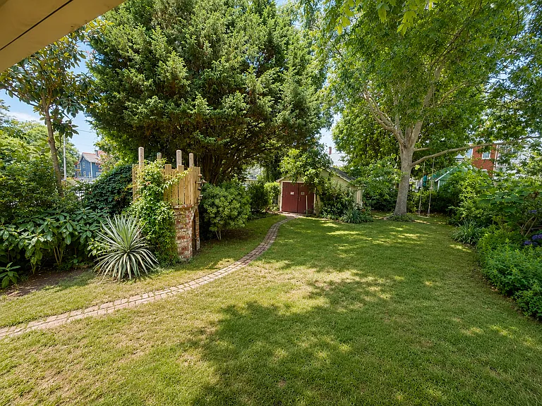 Fenced yard with large storage shed