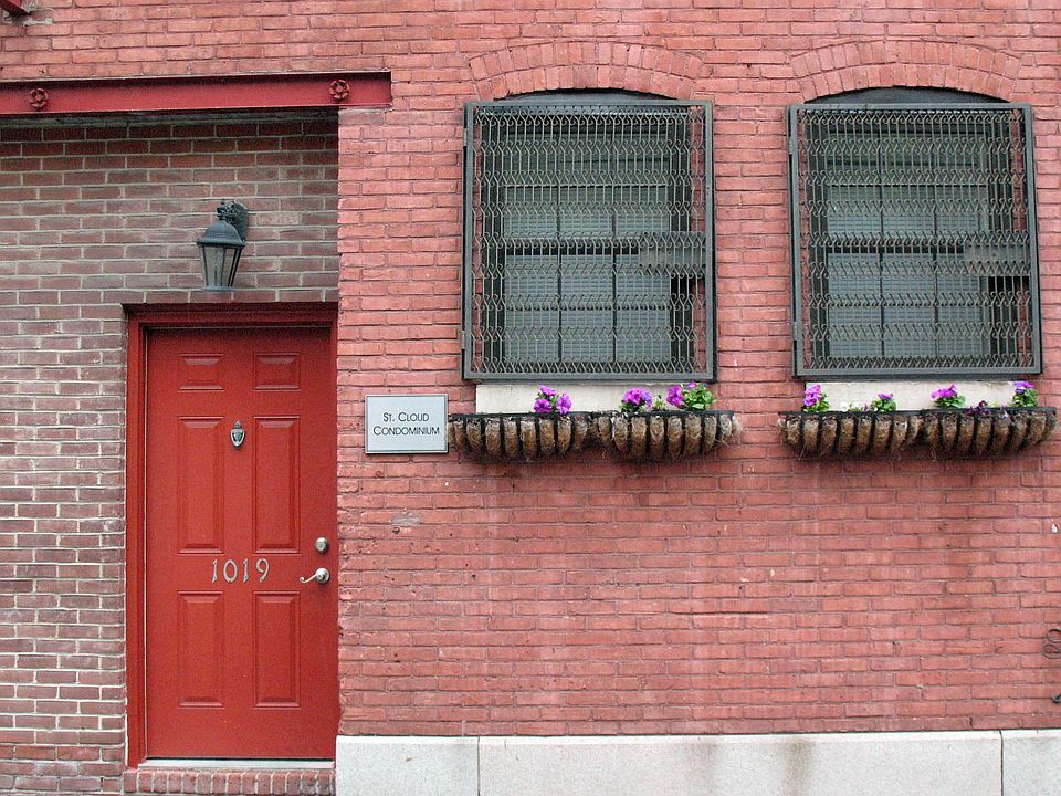 Historic carriage house facade with iron work detail on wind