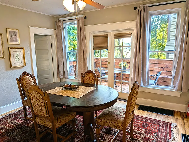 Dining Room with French doors that lead to deck. 1st floor bedroom is located to the left