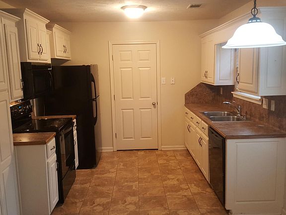 Kitchen with door leading to laundry