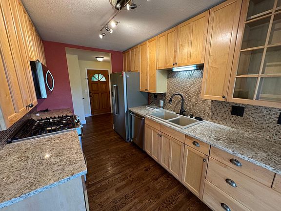Kitchen, with granite countertops, gas range, and stainless steel appliances.