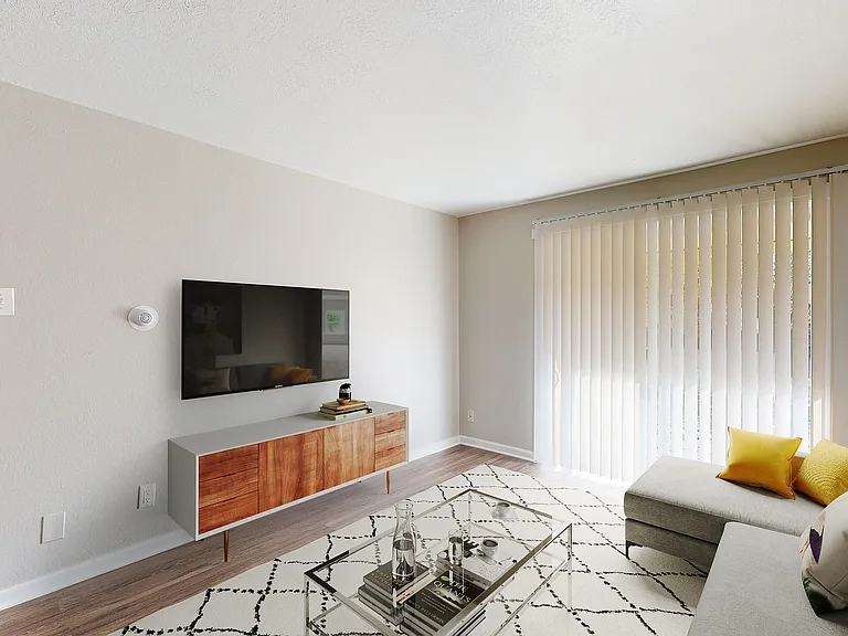 Contemporary living room with a sleek wall-mounted TV, stylish wooden cabinet, and bright natural light from tall vertical blinds.