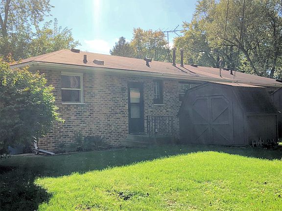 Small backyard is perfect for families to entertain and play safely. Back entryway and storage shed.